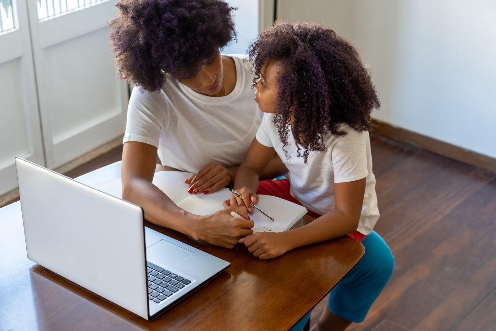 A parent and child working through homework together